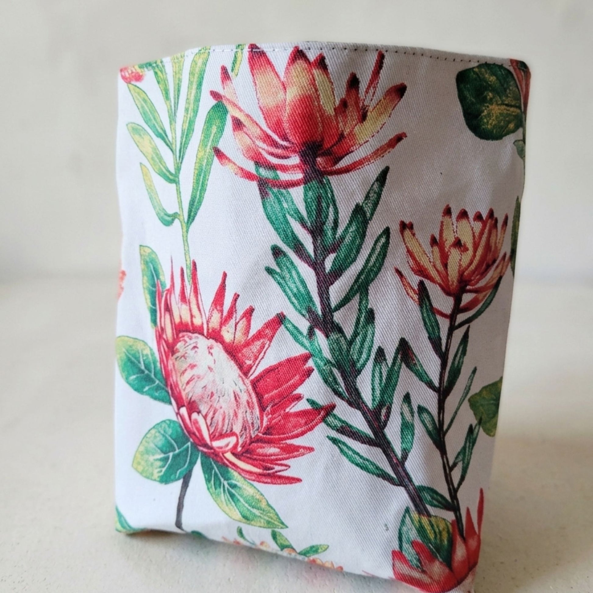 Floral patterned car bin with red and green flowers on a white background