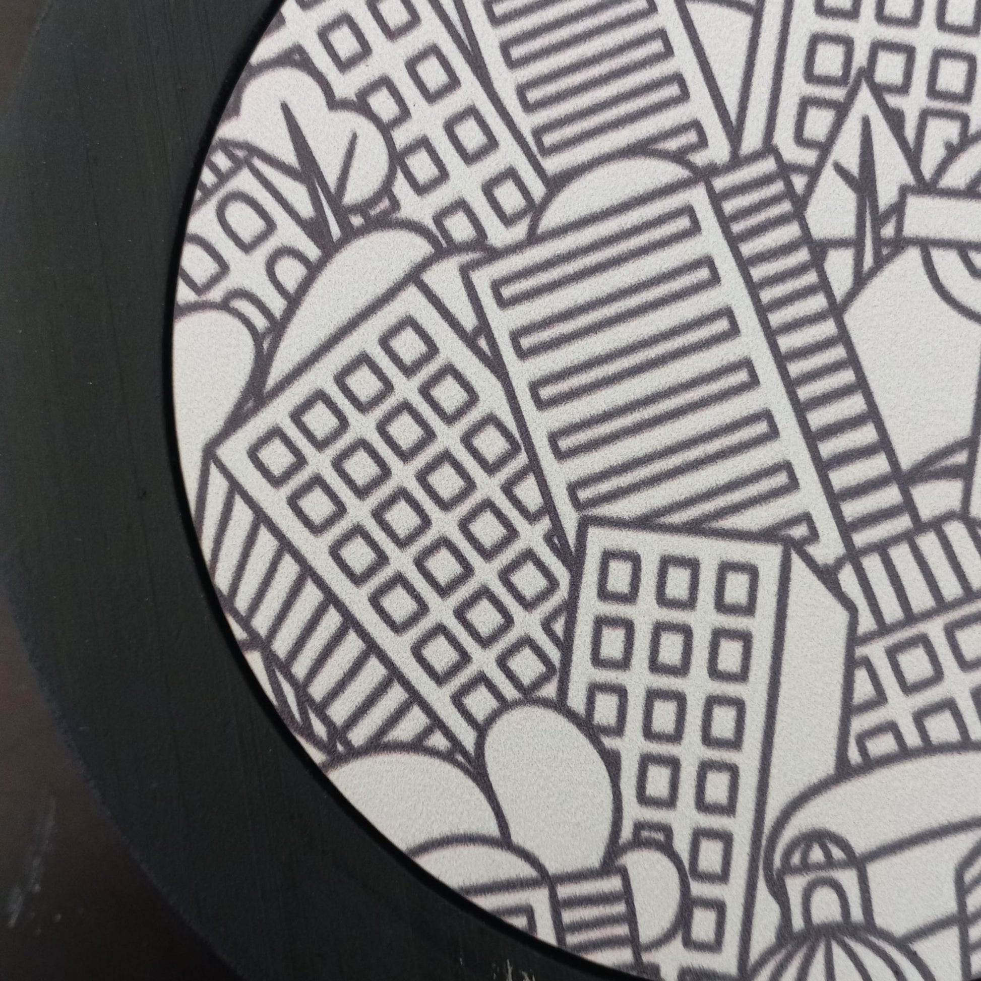 Black and white cityscape design on a circular object
