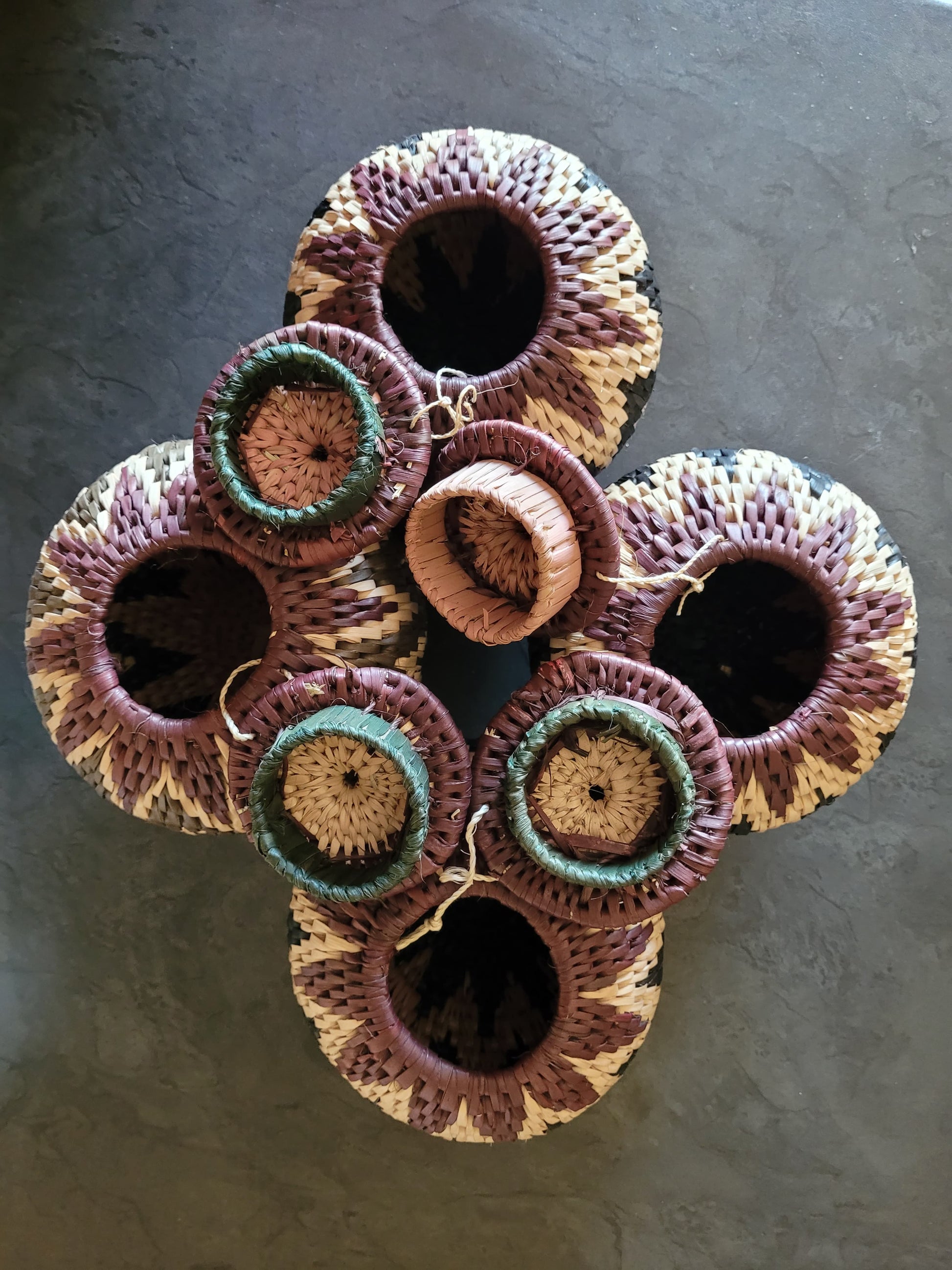 Set of woven baskets on a dark surface