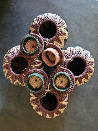 Set of woven baskets on a dark surface