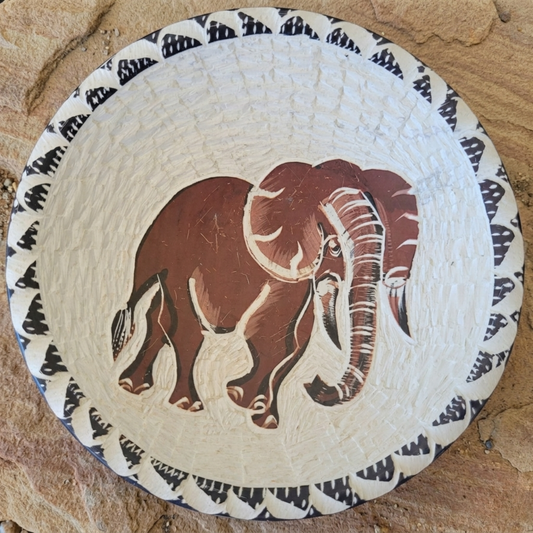 Decorative plate with an elephant design on a textured surface