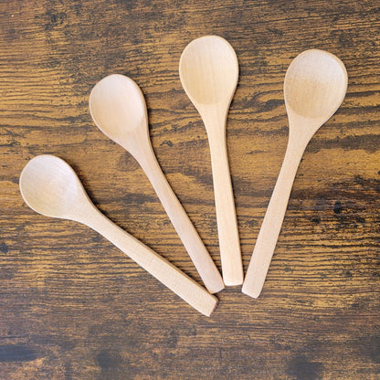 Four wooden spoons on a wooden surface