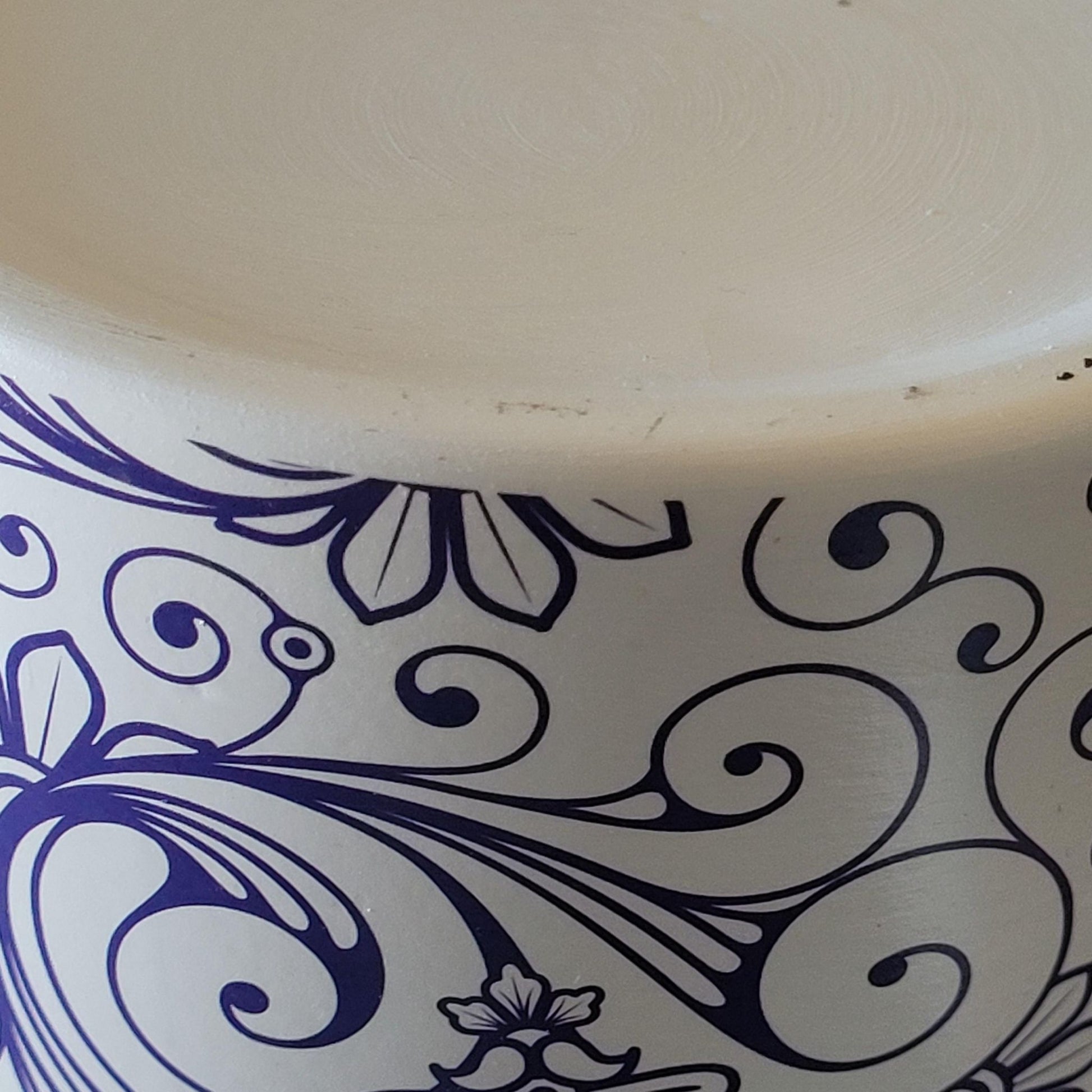Ceramic pot with blue floral patterns on a white background