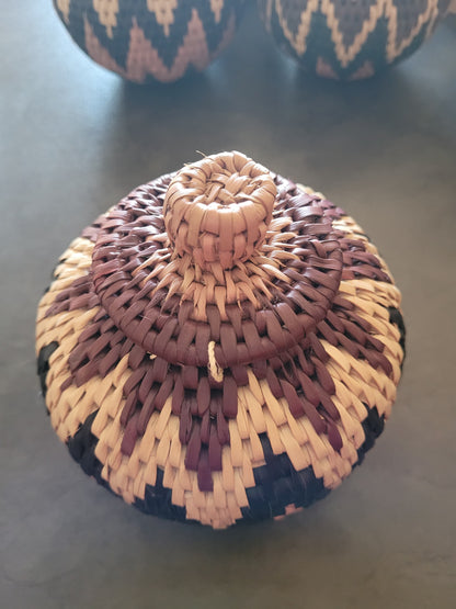 Woven lid on a spherical basket with a dark background