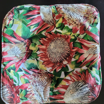 Floral patterned bowl cozy on a black background