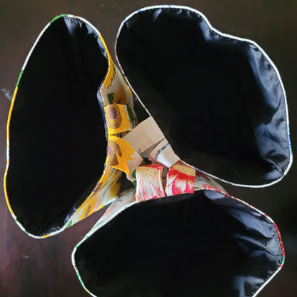 Colourful fabric with dark interior lining on a dark background