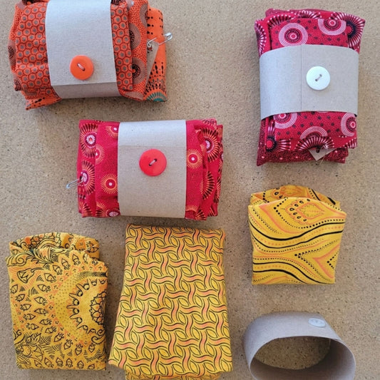 Collection of shweshwe fabric bowl covers on a beige surface